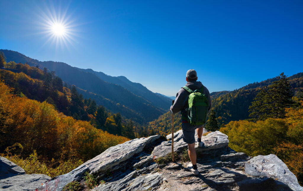 A guy hiking with a beautiful view.
