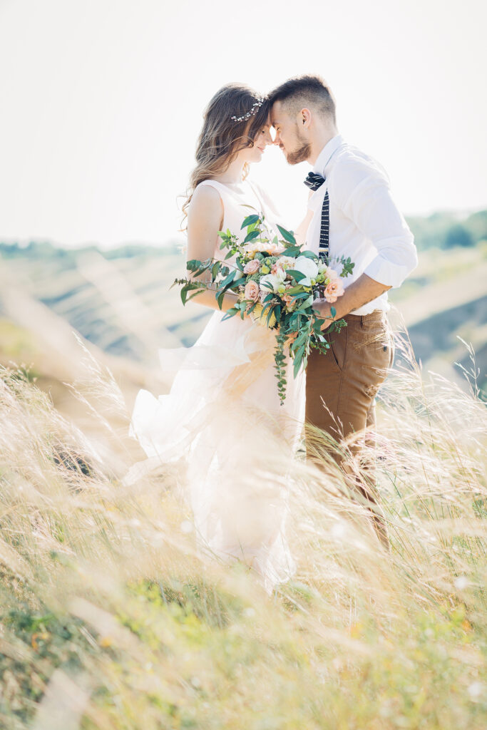 fine art wedding photography. bride and groom hugging at the wedding in nature.