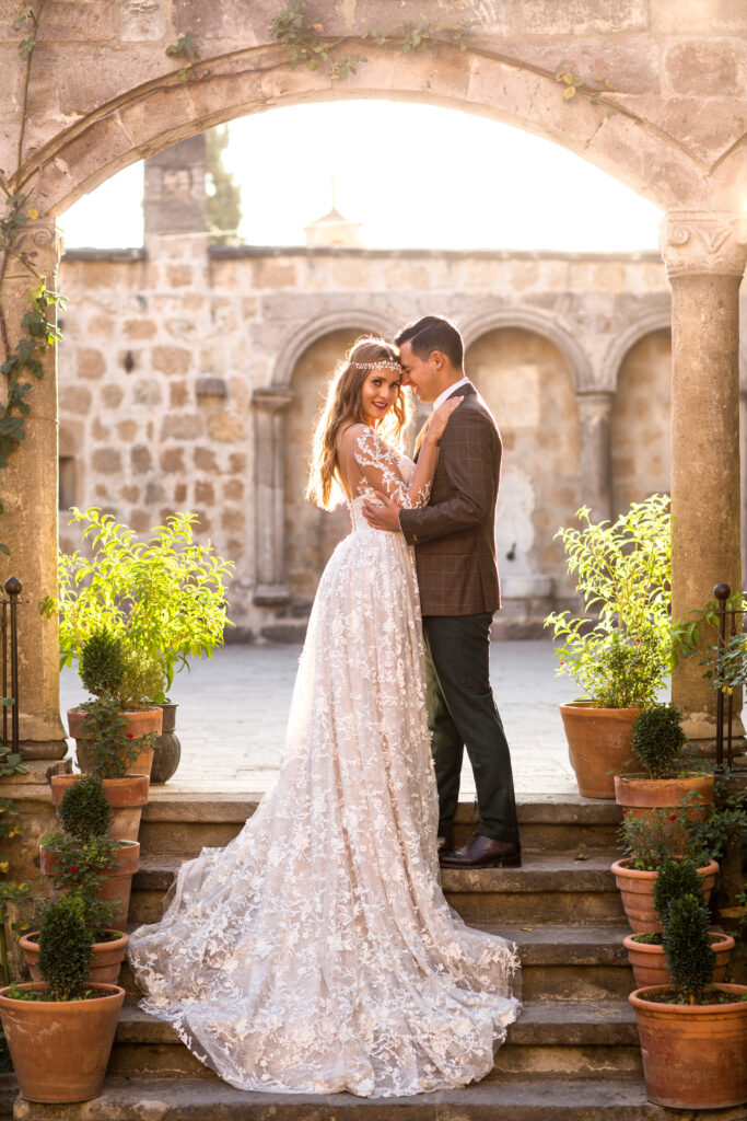 Beautiful wedding couple posing in old city.