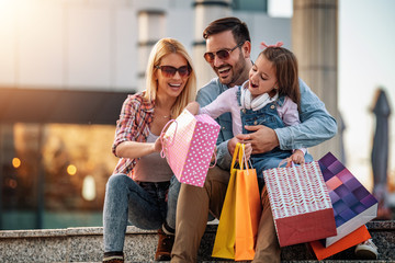Happy family with shopping bags having fun at the Dahlonega outlets