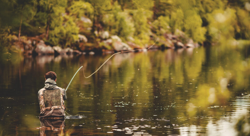 Fisherman using rod fly fishing in river morning sunrise banner.